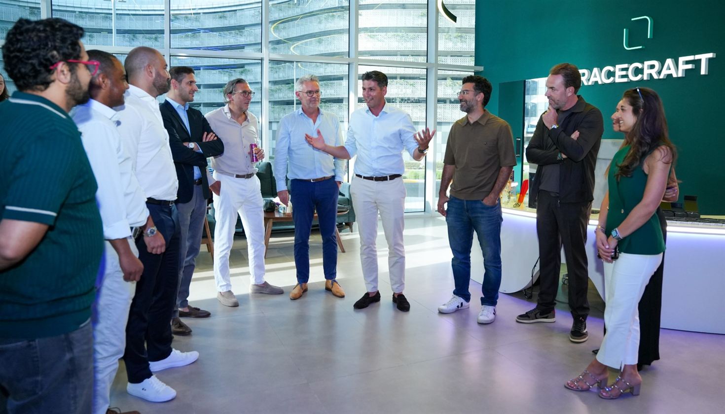 Guests gathered in the Racecraft venue beside the illuminated Racecraft wall