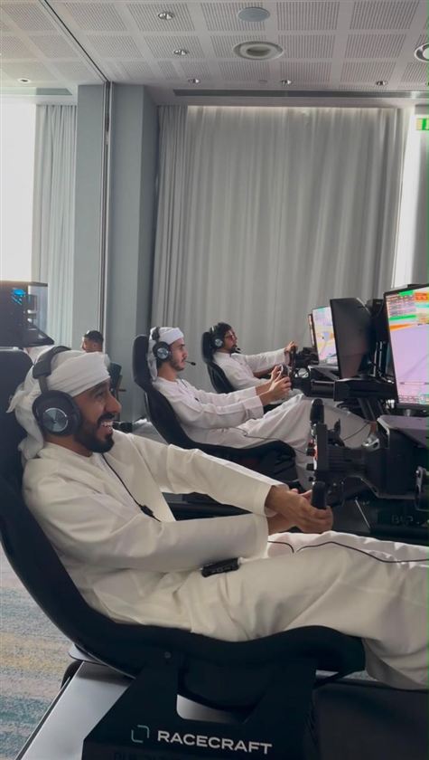 Guests laughing as they race on Racecraft simulators