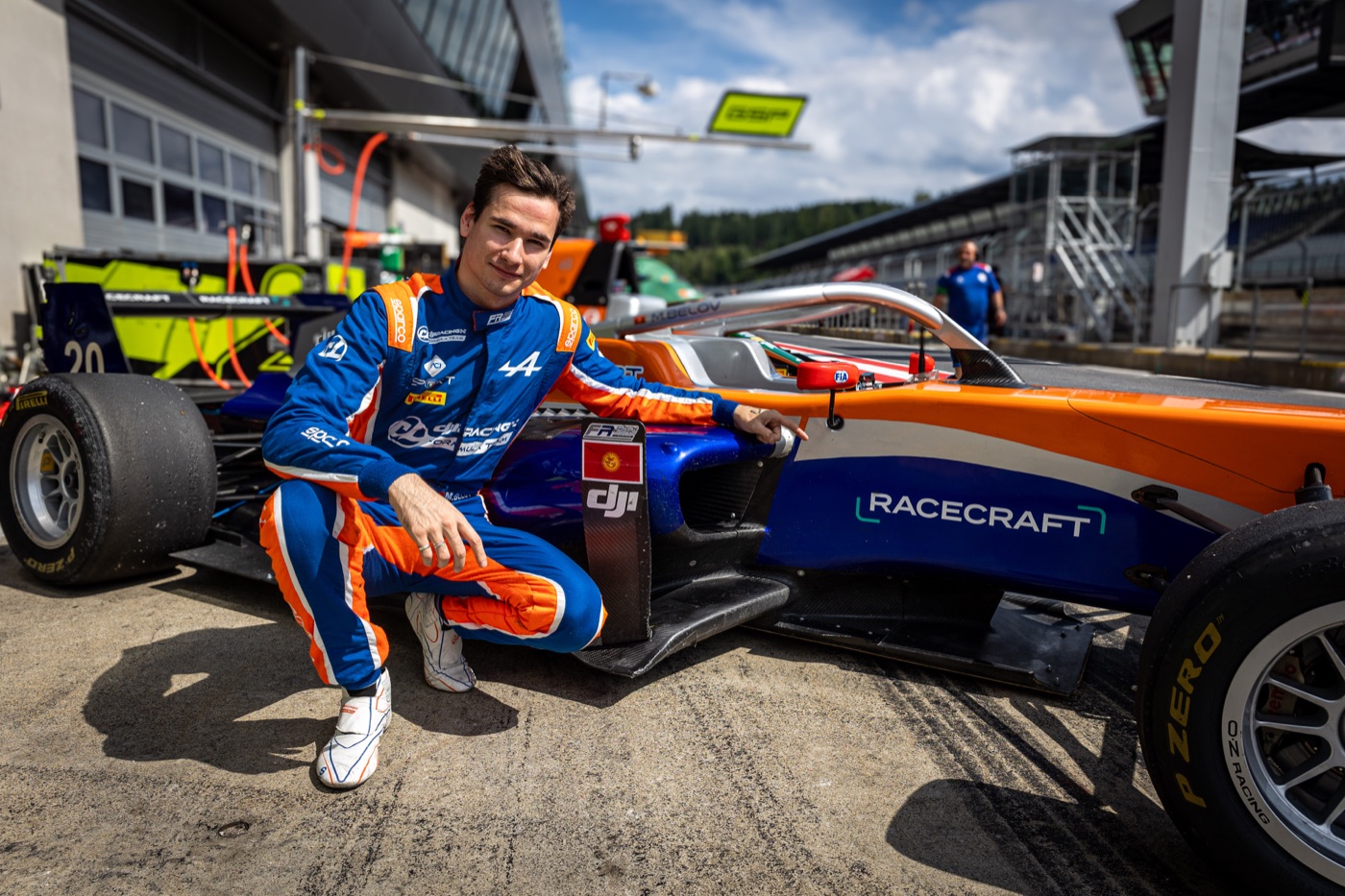 Racecraft Academy driver beside a Formula car