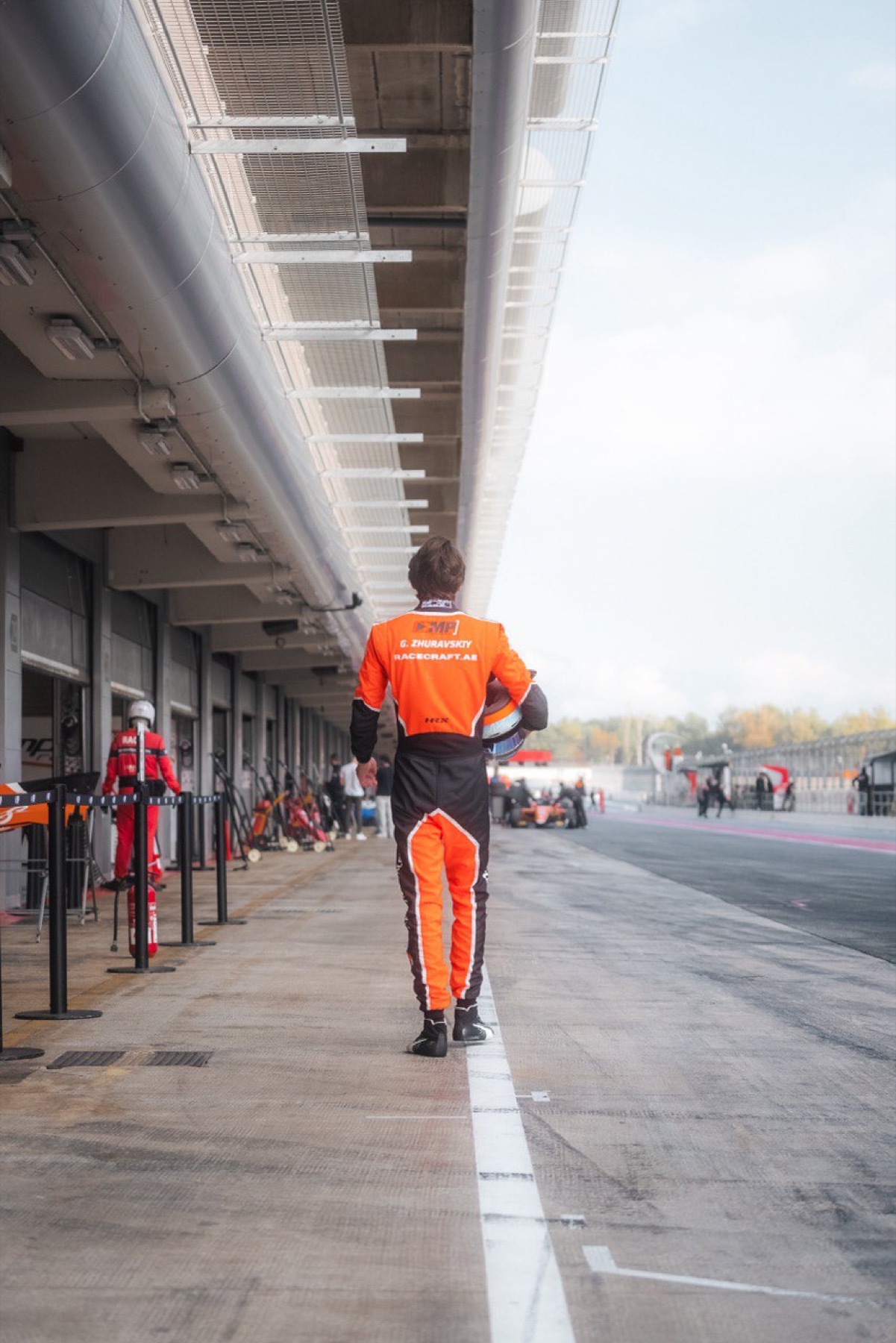 Racecraft driver walking through the pit lane
