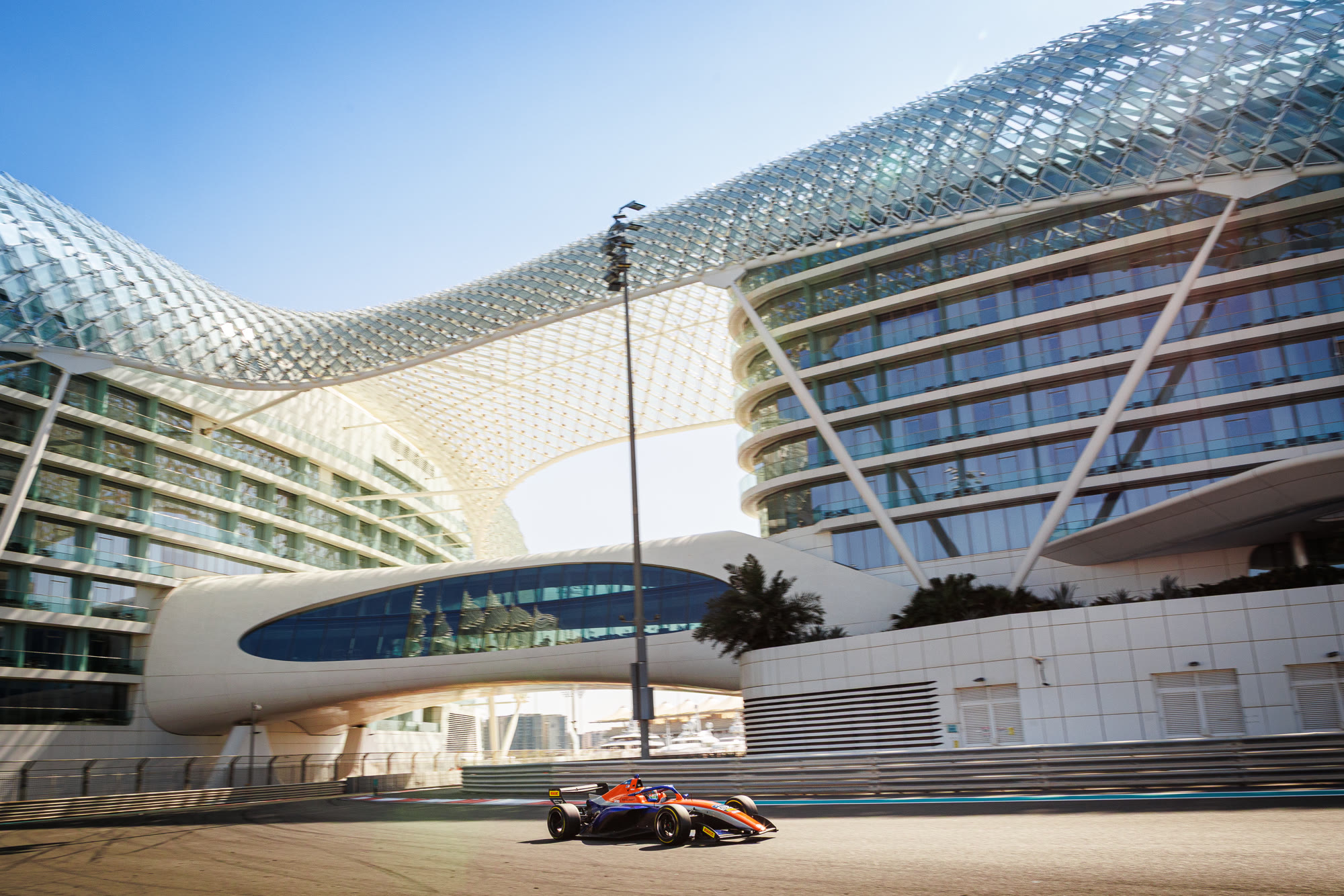 Race car passing W Abu Dhabi at Yas Marina Circuit